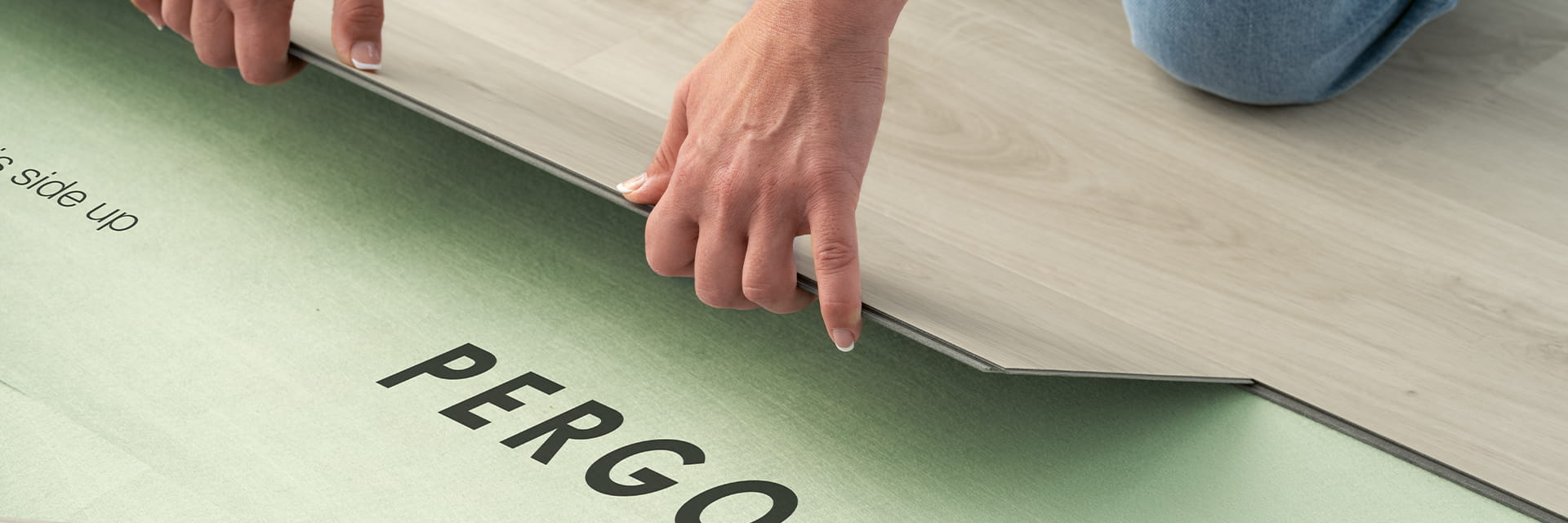 installation of a grey pergo vinyl floor on an underlay